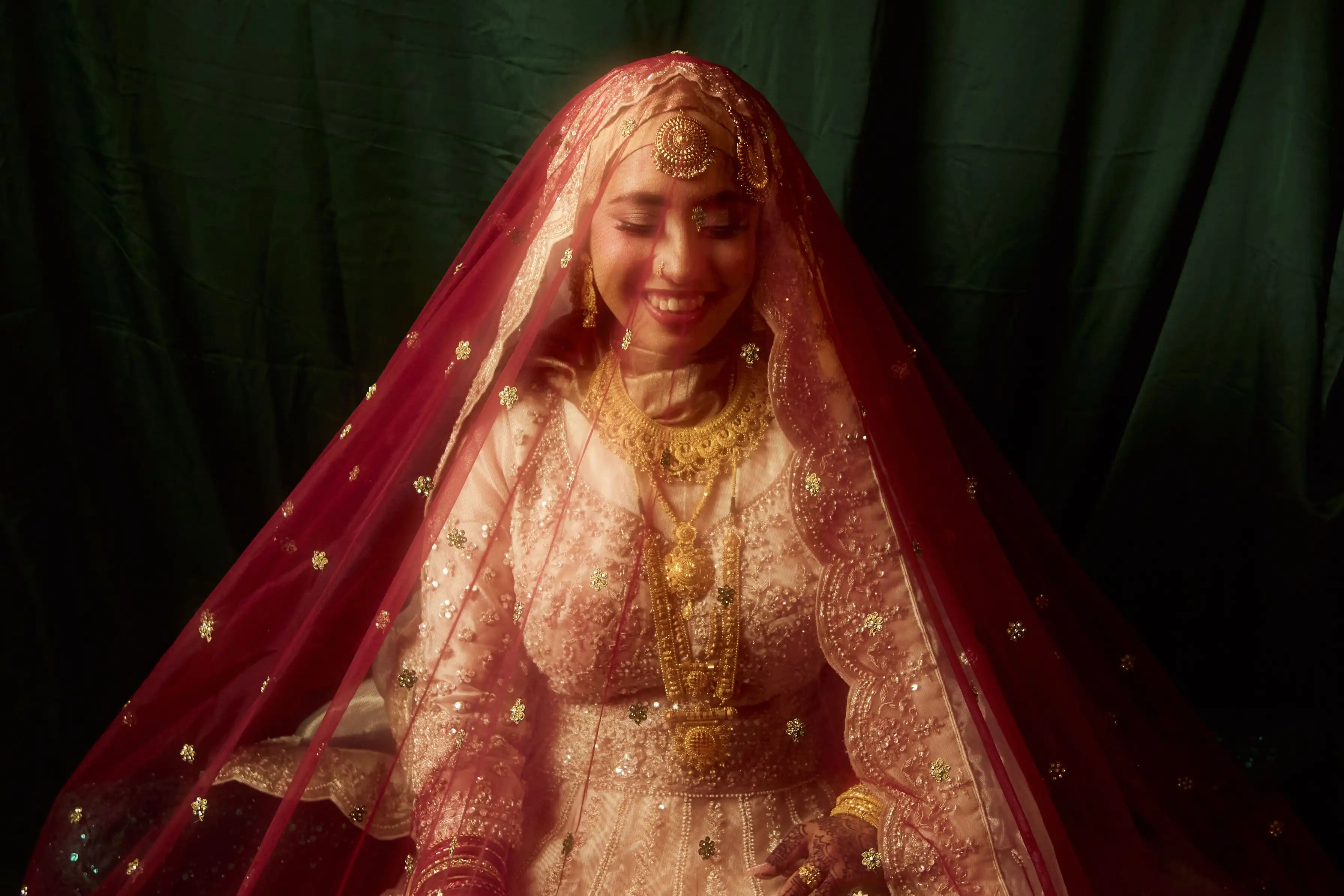 Bride in gold smiling warmly